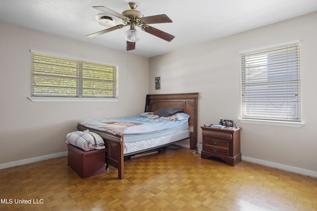 bedroom featuring baseboards and ceiling fan
