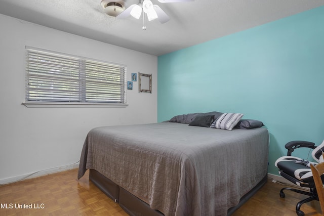 bedroom featuring baseboards and a ceiling fan