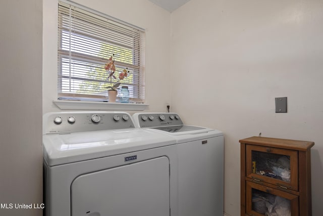 clothes washing area with laundry area and washer and clothes dryer