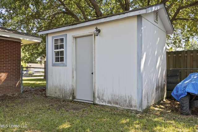 view of shed featuring fence