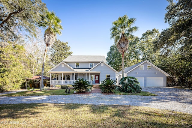 view of front facade with a porch, a garage, and a front lawn