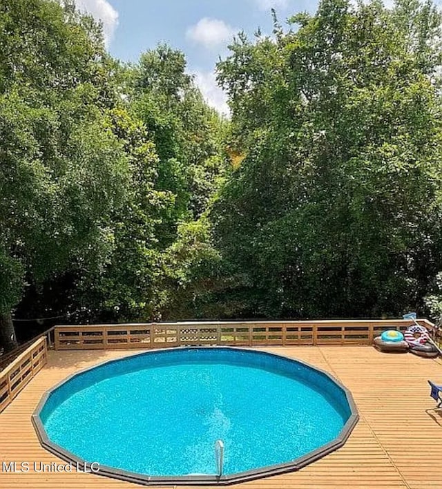 view of pool featuring a wooden deck