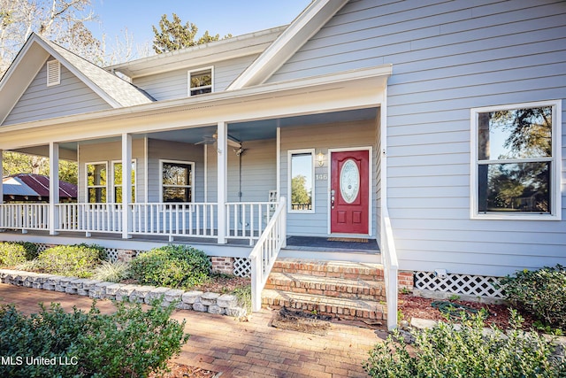 view of exterior entry featuring ceiling fan and covered porch