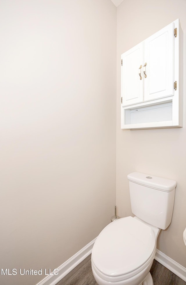 bathroom with hardwood / wood-style floors and toilet