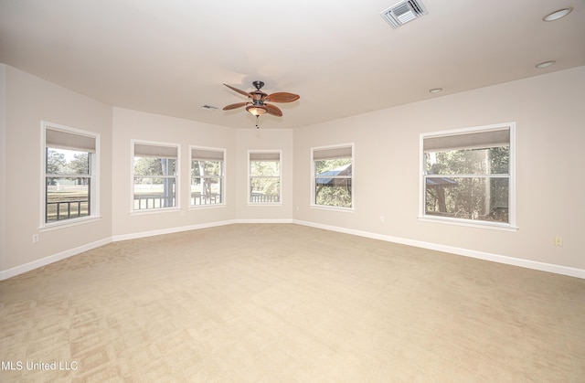 unfurnished room featuring ceiling fan and light colored carpet