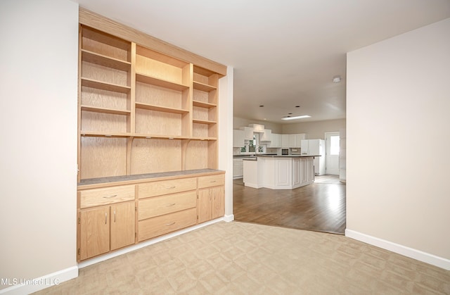 unfurnished living room featuring light carpet