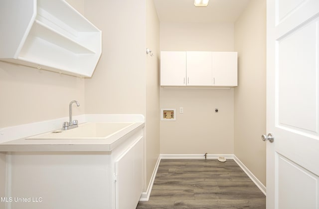 clothes washing area featuring sink, cabinets, electric dryer hookup, hookup for a washing machine, and hardwood / wood-style flooring