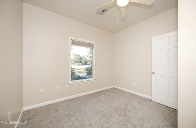 carpeted empty room featuring ceiling fan