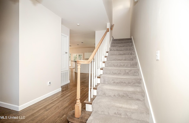 stairs with hardwood / wood-style floors