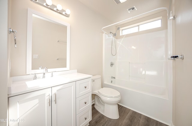 full bathroom featuring hardwood / wood-style flooring, vanity, toilet, and tub / shower combination