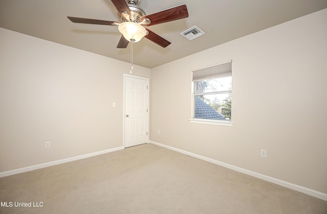 carpeted spare room featuring ceiling fan