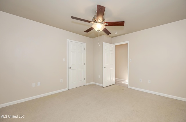 unfurnished bedroom with ceiling fan and light carpet