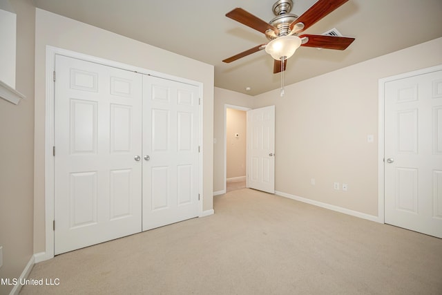 unfurnished bedroom with ceiling fan, a closet, and light colored carpet