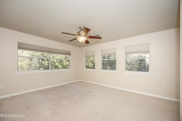 carpeted spare room featuring ceiling fan