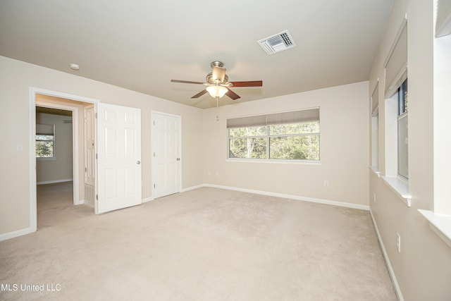 unfurnished bedroom with light carpet and ceiling fan