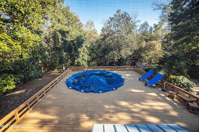 view of pool with a wooden deck