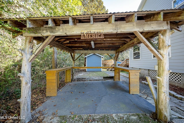 view of patio with a shed and a carport