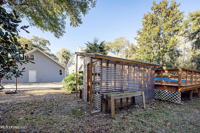 rear view of house featuring a wooden deck