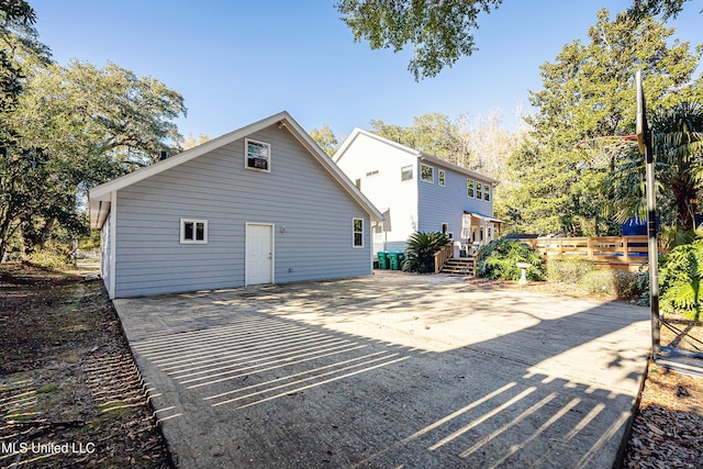 back of property with a wooden deck