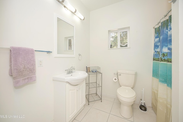 bathroom featuring tile patterned floors, vanity, and toilet