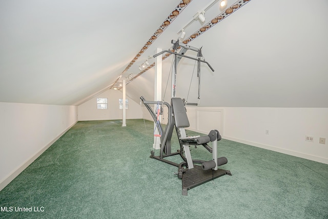 exercise area featuring carpet and vaulted ceiling