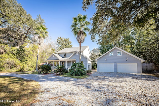 view of front of home featuring an outdoor structure, a porch, and a garage