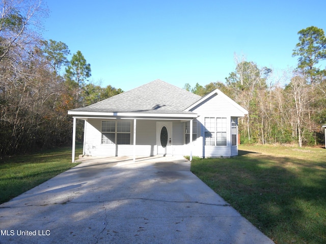 view of front of property with a front lawn and a carport