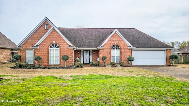 view of front facade with a front yard and a garage