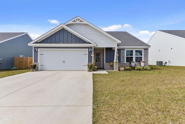 craftsman house with concrete driveway, an attached garage, board and batten siding, fence, and a front lawn