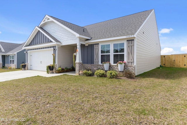 craftsman-style house with concrete driveway, an attached garage, fence, board and batten siding, and a front yard