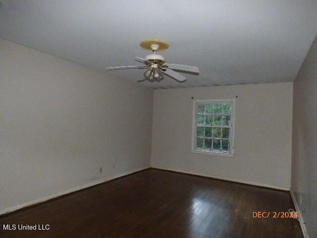 spare room with dark wood-type flooring