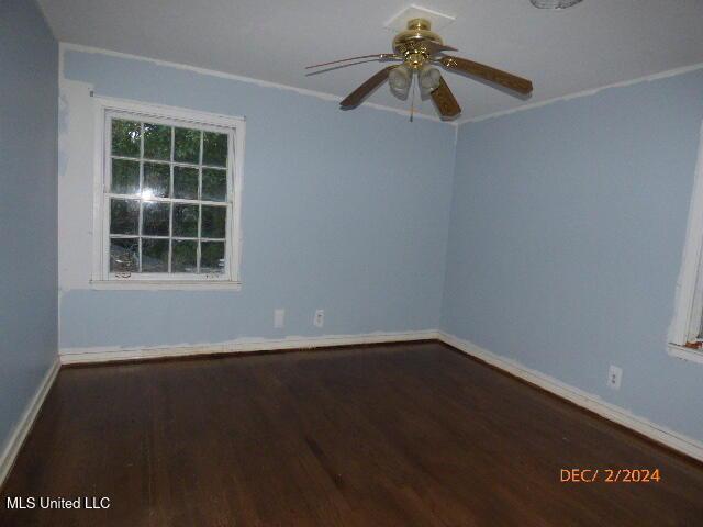 spare room featuring ceiling fan and dark hardwood / wood-style flooring