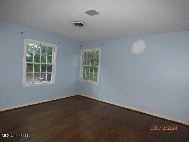 spare room featuring dark hardwood / wood-style floors