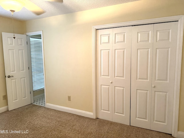 1606 Woodhaven St, Pascagoula, MS 39581 - unfurnished bedroom with carpet flooring, a closet, baseboards, and ceiling fan