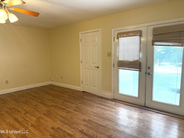 1606 Woodhaven St, Pascagoula, MS 39581 - unfurnished room with wood finished floors, a ceiling fan, baseboards, and french doors