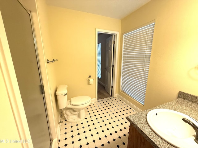 1606 Woodhaven St, Pascagoula, MS 39581 - full bathroom featuring vanity, a stall shower, toilet, and baseboards