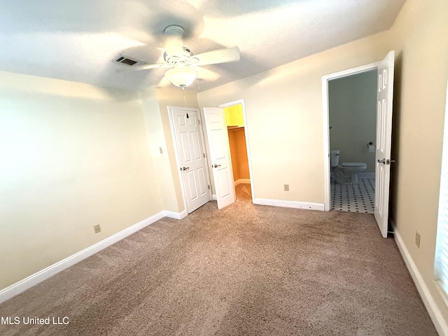 1606 Woodhaven St, Pascagoula, MS 39581 - unfurnished bedroom with carpet flooring, baseboards, connected bathroom, and a spacious closet