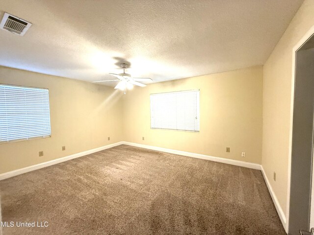 1606 Woodhaven St, Pascagoula, MS 39581 - unfurnished room featuring carpet floors, ceiling fan, baseboards, and a textured ceiling
