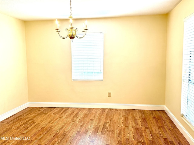 1606 Woodhaven St, Pascagoula, MS 39581 - unfurnished room featuring a chandelier, wood finished floors, and baseboards