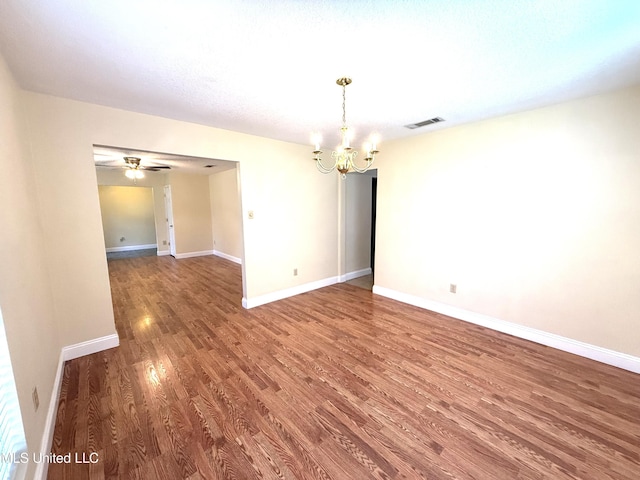 1606 Woodhaven St, Pascagoula, MS 39581 - unfurnished room with a chandelier, wood finished floors, baseboards, and a ceiling fan