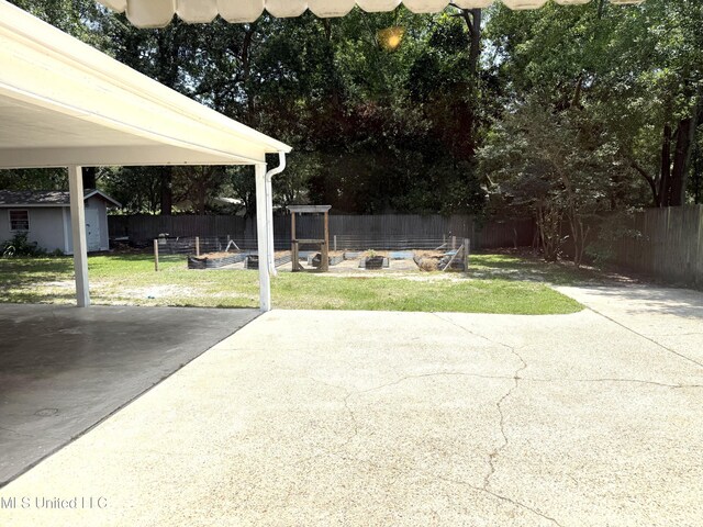 1606 Woodhaven St, Pascagoula, MS 39581 - view of patio / terrace with a vegetable garden and an outbuilding