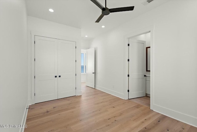 unfurnished bedroom with ceiling fan, light hardwood / wood-style floors, connected bathroom, and a closet