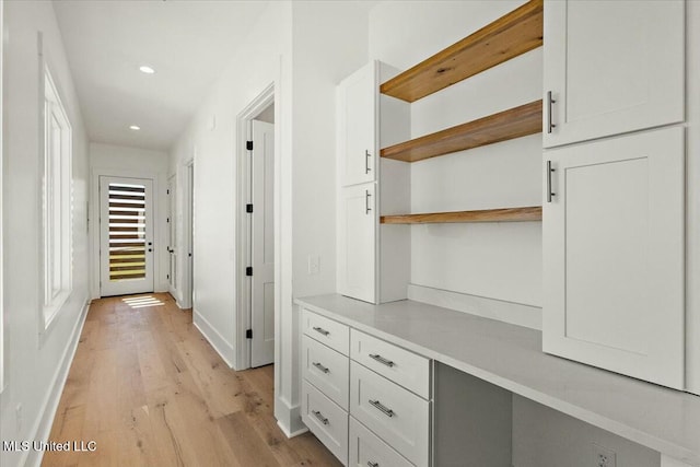 hallway with light hardwood / wood-style flooring