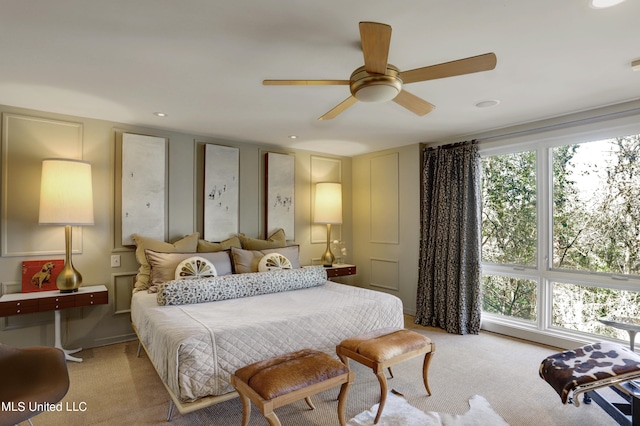 bedroom with ceiling fan and light colored carpet