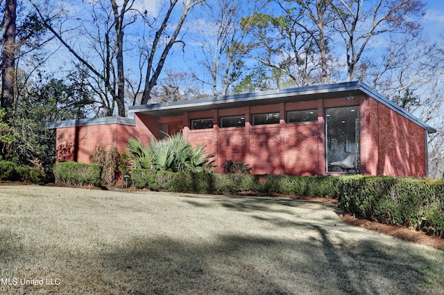 view of property exterior with a lawn