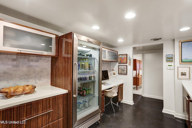 kitchen featuring built in desk and tasteful backsplash