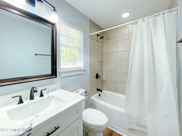 full bathroom with vanity, shower / bath combination with curtain, and toilet