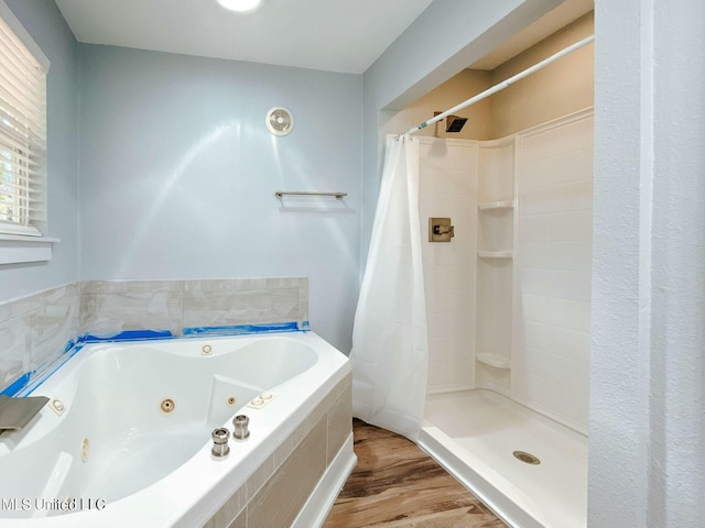 bathroom featuring wood-type flooring and plus walk in shower