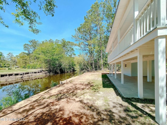 view of yard with a water view and a patio area