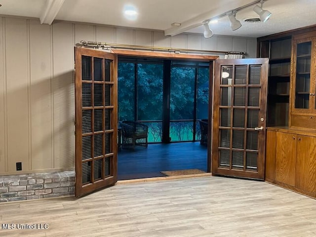 entryway featuring track lighting and light hardwood / wood-style flooring